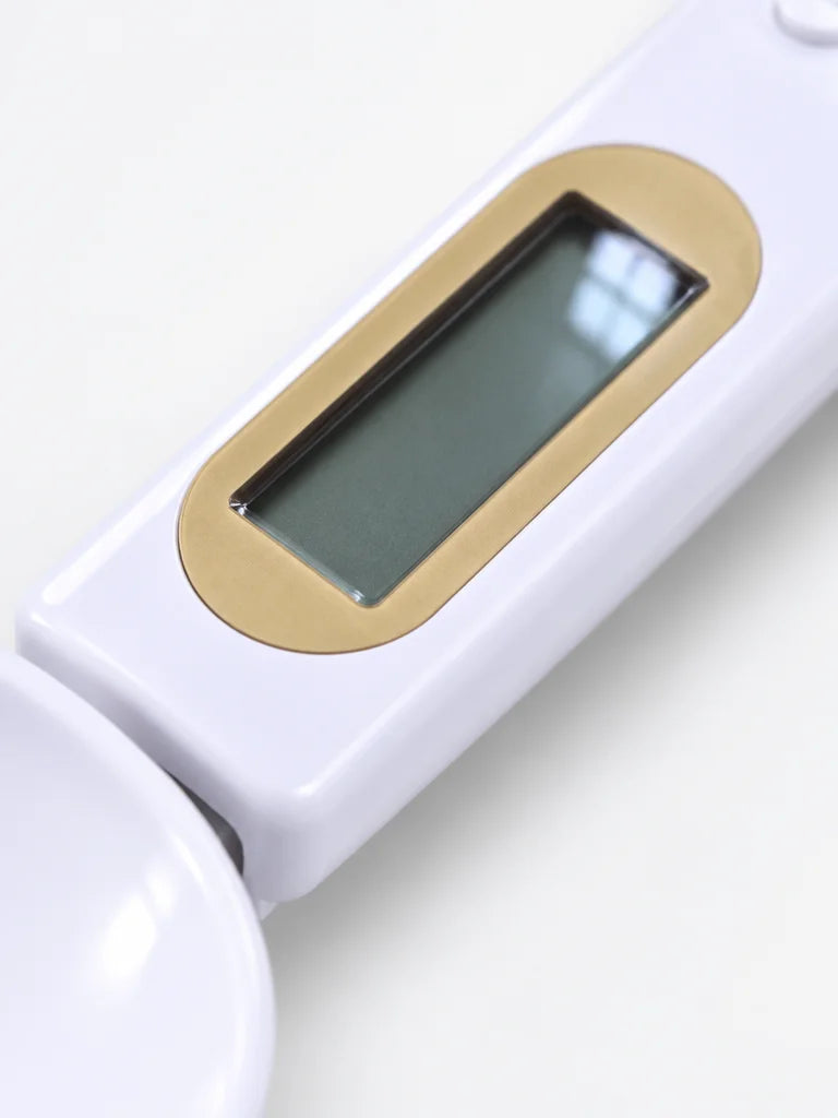 An extreme close macro photograph of the white Doseo spoon scale’s LCD area, the narrow rectangular