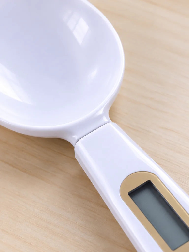 A tight macro photograph of the white Doseo digital spoon scale’s real bowl-to-handle junction while
